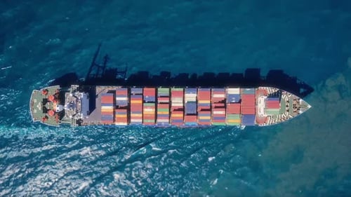 A Stunning Aerial View of a Cargo Ship Surrounded By Colorful Containers in Clear Blue Waters