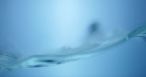 Water Surface Slow Motion Abstract Background. Bubbles rise to the surface. Fresh water waves with s