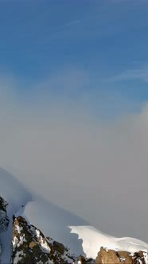 Snowy Mountain Peak Above The Clouds. British Columbia, Canada.