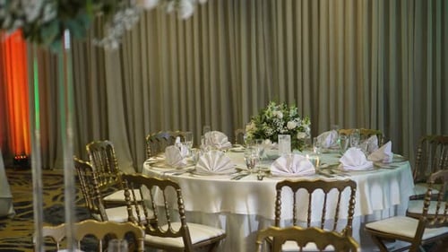 Elegant Wedding Reception Table Setting with Floral Centerpiece