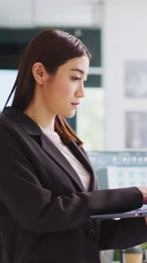 Vertical Video Developer Makes Sketches on Laptop for Construction Program