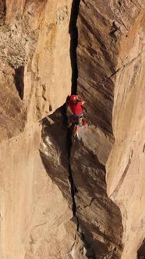 Man Climber Rock Climbing Crack Trad Climbing Aerial View Vertical Video