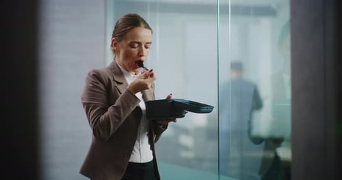 Businesswoman or Office Worker Eats Food From Delivery During Lunch in Modern Office