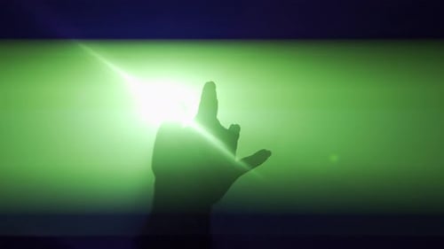 Silhouette in Lighting Concept Female Model Against Bright Green Light on Black Smoky Background in