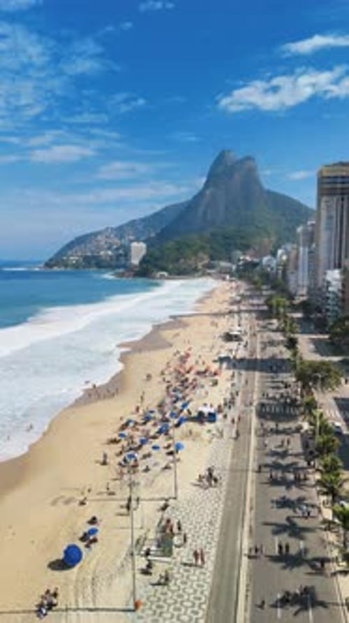 Vertical: Drone Flying Over Leblon Beach and Closed Road with Mountains and Ocean