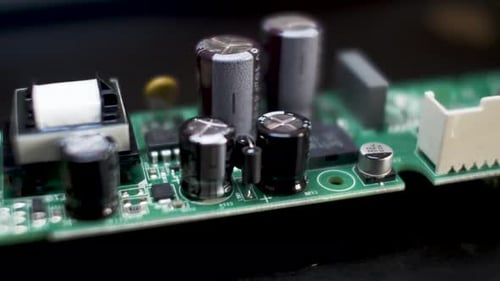 Close Up View Of Radial Electrolytic Capacitors Mounted On PCB. Slow Dolly Parallax Right Shot