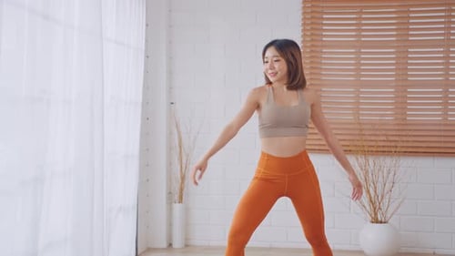 Young Woman Doing Yoga Stretch Indoors