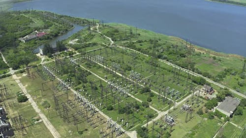 Aerial view of a coal power plant emitting smoke by water