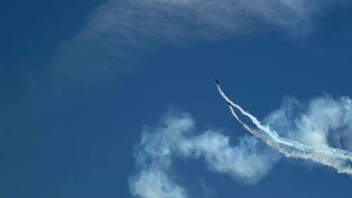 Two Planes Perform Aerial Stunts in Blue Sky