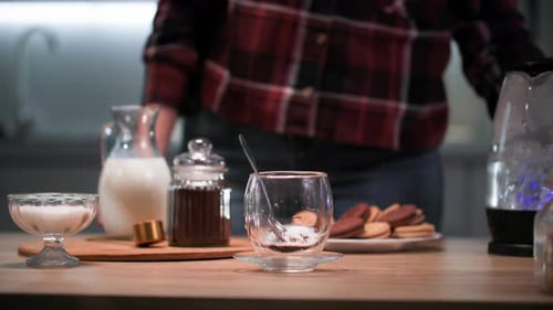 Woman Preparing Coffee with Milk and Sugar Indoors