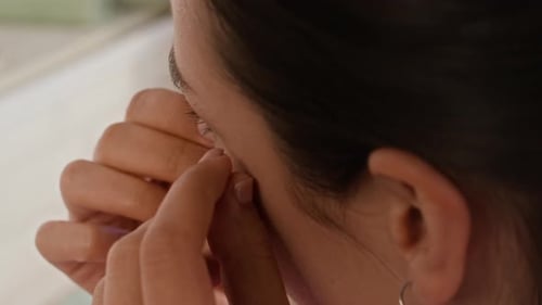 Woman Applies Glittery Cosmetic Eye Mask