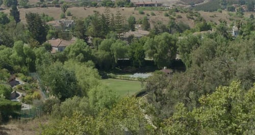 Wedding Ceremony Setup On Golf Course in California - Aerial Reveal From Trees