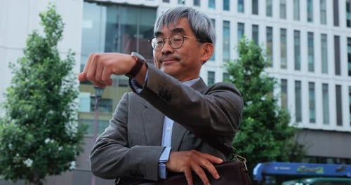Mature Man Checking the Time in City