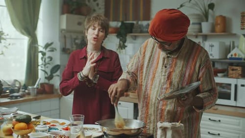 Two People Cooking Together in a Sunny Kitchen