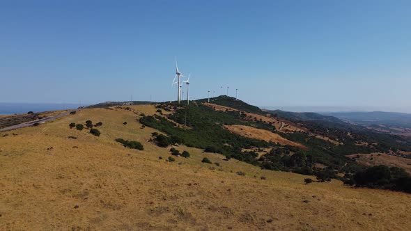 Windmill farm on top of Spanish mountain, aerial side fly view ...