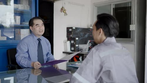Mechanic repairman pass job interview sit in front of Business man answers questions shake hands