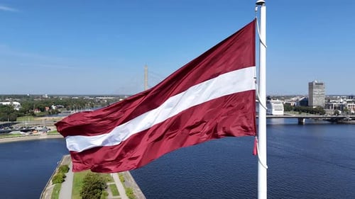 Aerial View of Lithuanian Flag Waving in the Wind with View of Daugava River and Vansu Bridge on a