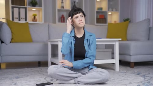 Thoughtful Young Woman Sitting in Home