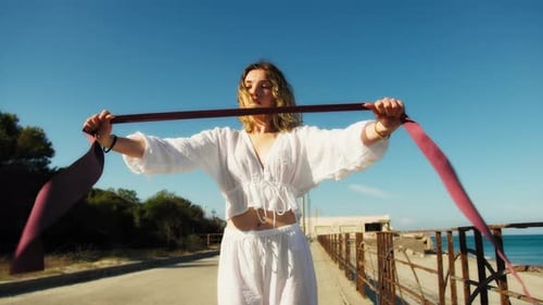 Young Woman Exercises Muscles At Elastic Gym Outside