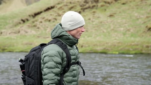 Man With Backpack Hiking By River