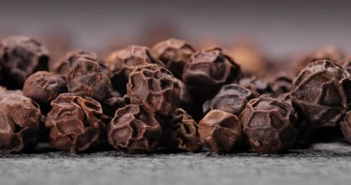 Peppercorns or black pepper spice. Super Macro Close Up.