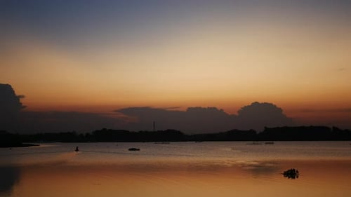 Tropical Lake Sunset with Boat on the Water