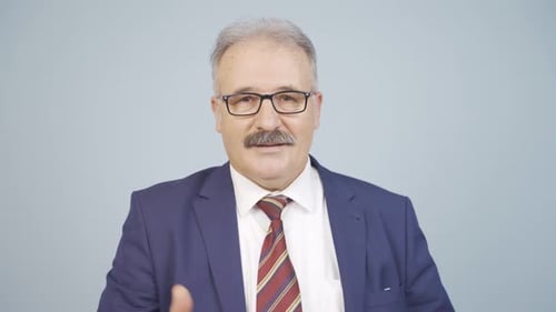 Man in Suit Gestures and Gives Thumbs Up