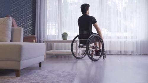 Man in Wheelchair Moving Through Living Room