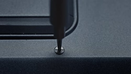 a Close Up of a Screw Being Screwed Into a Piece of Plastic Assembling the Laptop Case