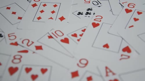 Playing Cards Scattered on a White Surface