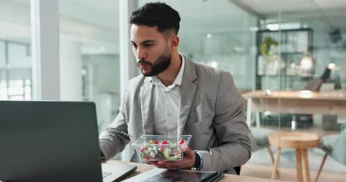 Laptop, salad and a business man eating in the office while working on research for a report