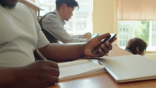 Students Studying and Taking Notes in Class