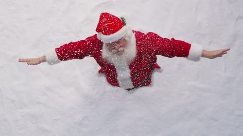 Santa Playing In The Snow. Overheard Shot. Slow Motion