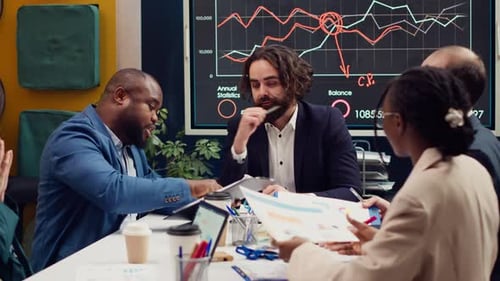 Team Reviewing Charts During Corporate Meeting