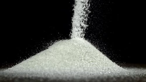 White Sugar Falls on the Table in a Heap Filmed on a Highspeed Camera at 1000 Fps