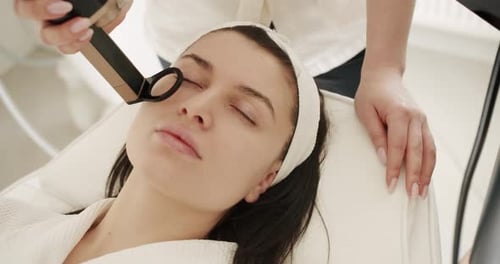 Woman Receives Facial Treatment in Spa Setting