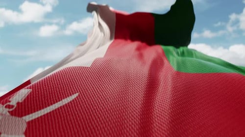 Waving Oman Flag with Realistic Fabric Texture against Blue Sky