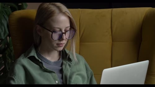 Blonde Woman Working on Laptop at Home
