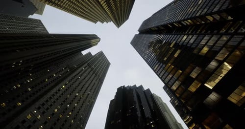 Tall Buildings Reach Towards the Sky in a Modern City at Dusk