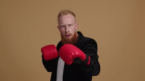 Man with Boxing Gloves Punches Toward Camera
