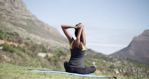 Woman Stretching Outdoors on Yoga Mat in Mountains