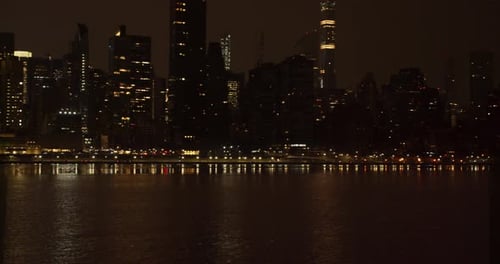 New York City night panning shot of Manhattan skyline. Looking across East River panning towards Ed