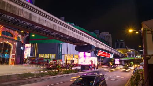 Timelapse of Modern City Intersection at Night Car Light Trails Bright Urban Lights Ads People Cross