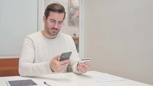 Excited Young Man Enjoying Online shopping on Smartphone