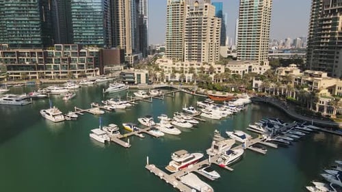 Aerial Drone Footage of Dubai Marina Waterfront, Skyscrapers, Boats, and Yachts, Dubai, UAE