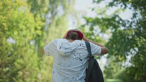 Teen Walking Along Nature Trail Teen Exploring Wooded Area with Backpack Under Summer Sun Young
