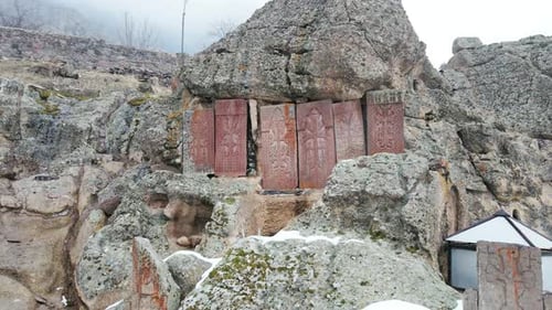 Natural Shot in Aerial Drone Flight Snow Covered Stone Rocks Cliffs Nature with Historical Monument