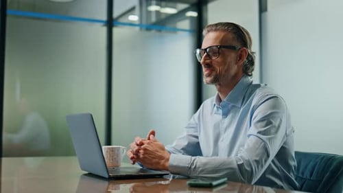 Man in Office Video Conference with Laptop