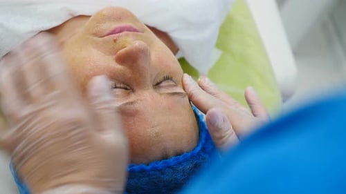 Adult Woman Receiving a Facial Massage at Clinic