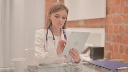 Female Doctor using Tablet in Clinic